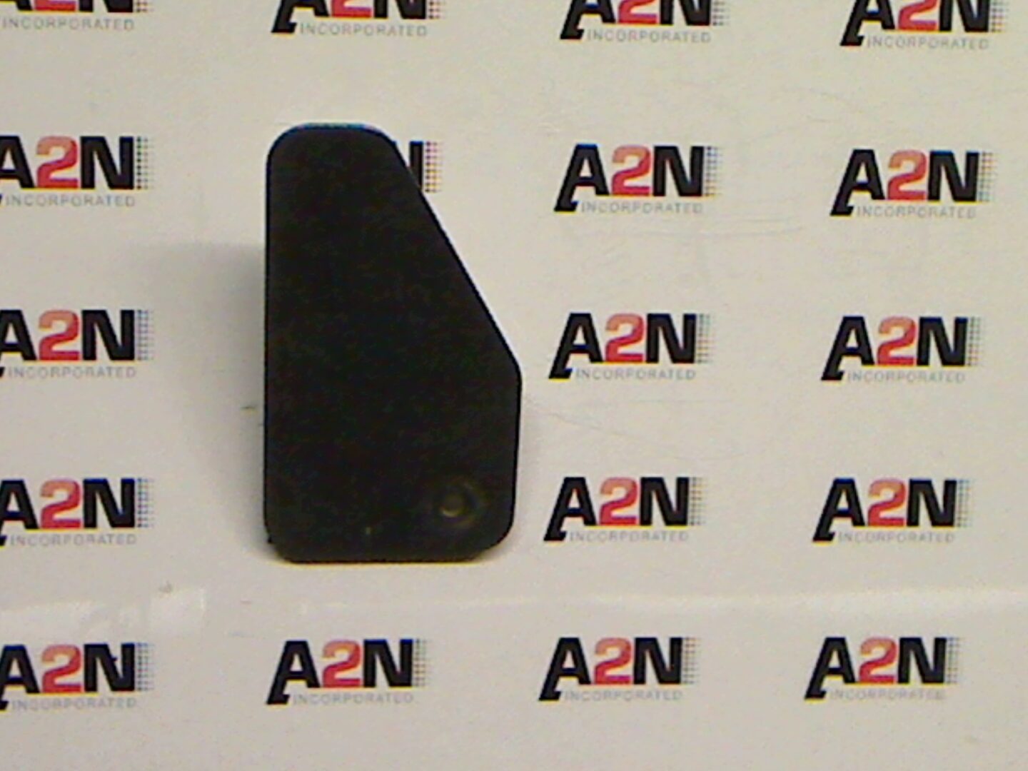 Black object with angled edge on white background.