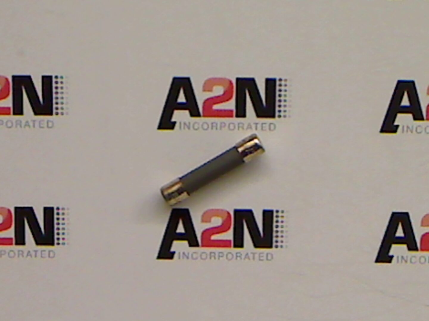 Gray cylindrical object on branded background.