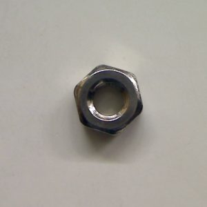 Metal nut on a plain background.